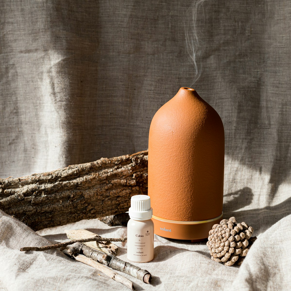 Photo by volant a bottle of liquid sitting next to a pile of wood